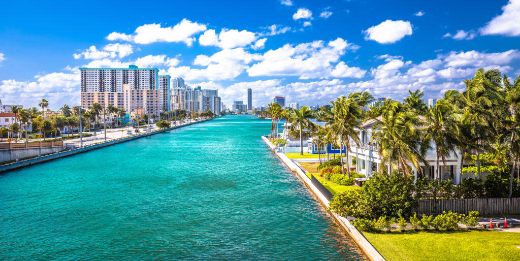 Palm-lined South Florida canal with turquoise water