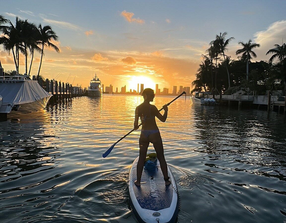 Stand-up paddleboarder at sunset on Biscayne Bay
